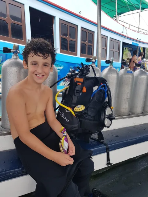 Young diver smiling on the boat