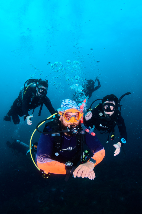 Divemaster instructor guiding a group of divers