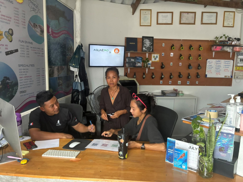AquaTao team at the front desk with a customer